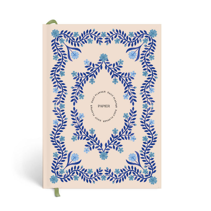 Notebook with blue floral design on a beige background