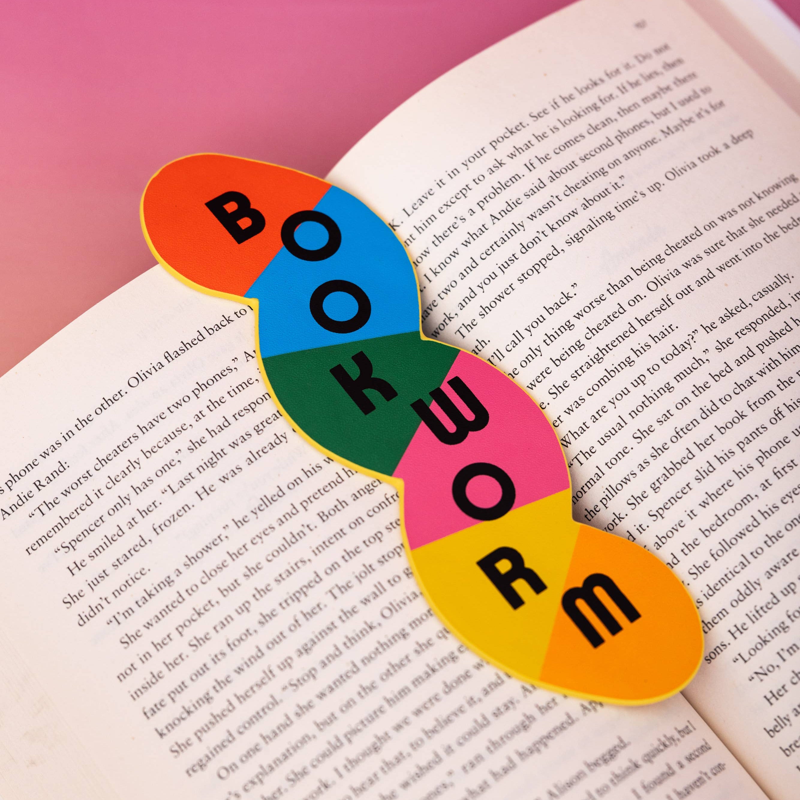 Colorful 'BOOKWORM' bookmark on an open book with a pink background