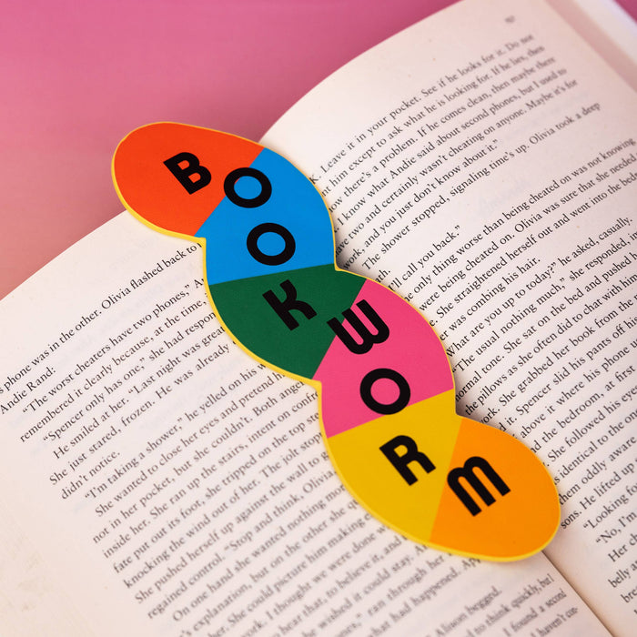 Colorful 'BOOKWORM' bookmark on an open book with a pink background