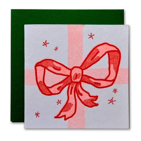 Card with a red bow design on a white background