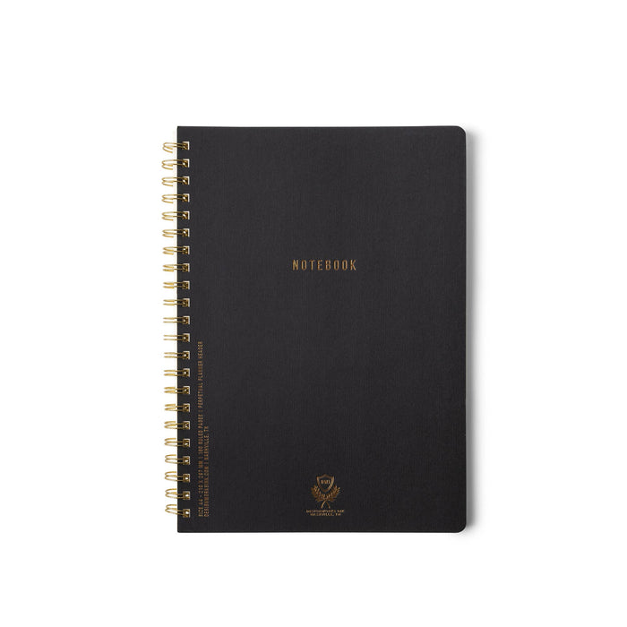 Black notebook with gold spiral binding on a white background