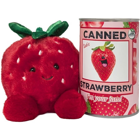 Plush strawberry toy next to a can of 'Canned Strawberry' with a smiling strawberry on the label.