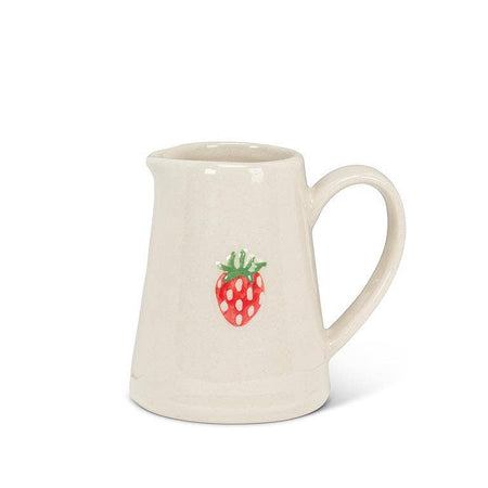White ceramic pitcher with a strawberry design on a white background