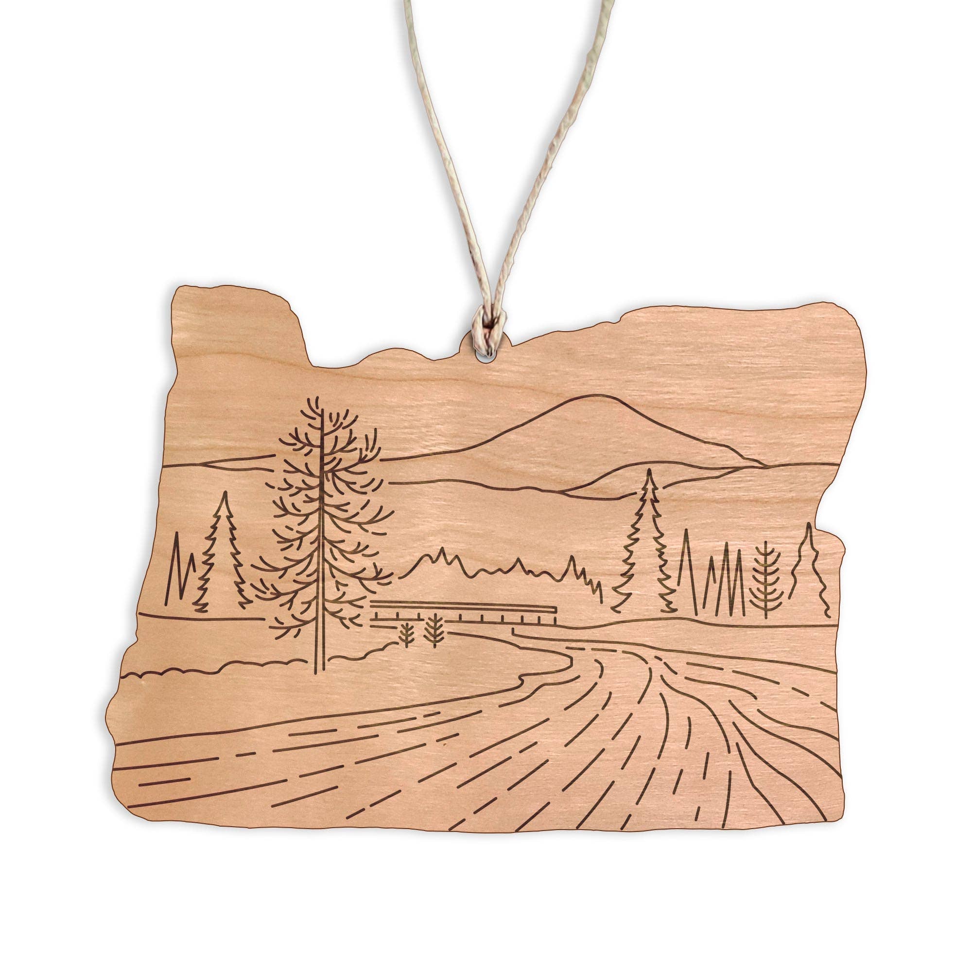 Wooden ornament shaped like the state of Oregon with a Sunriver landscape engraving on a white background.