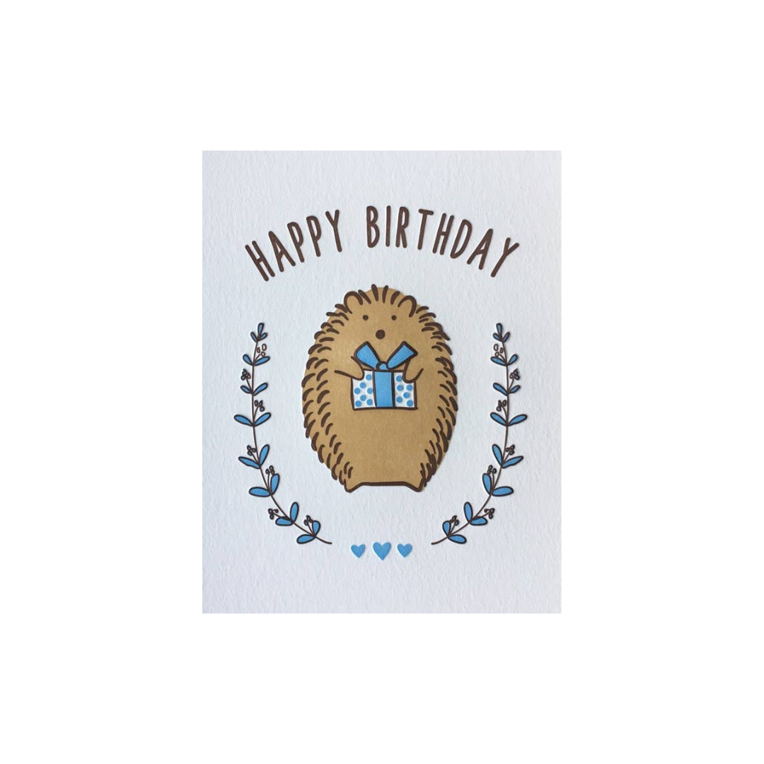 Birthday card with a hedgehog holding a gift and 'Happy Birthday' text on a white background