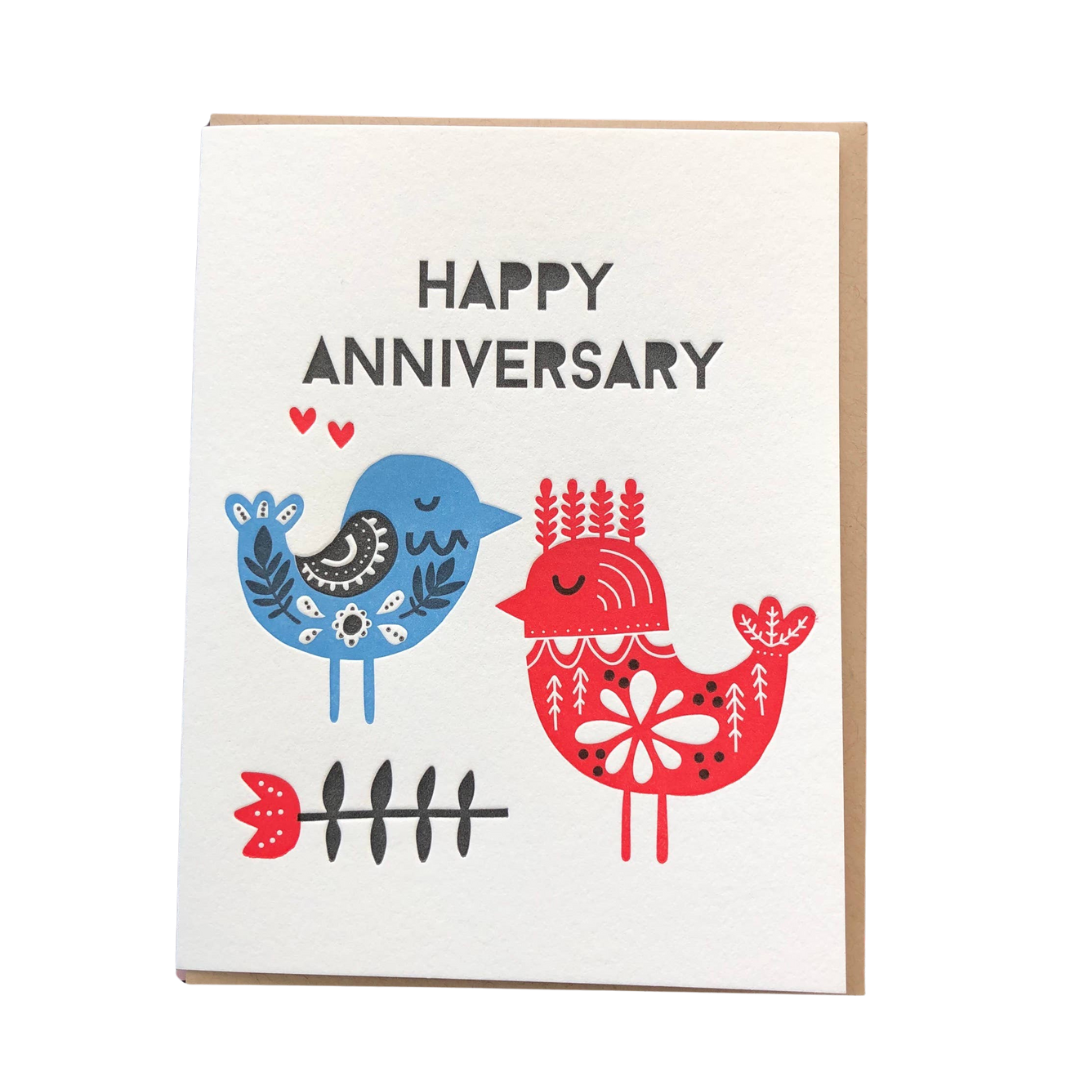 Anniversary card with two birds, one blue and one red, on a white background.
