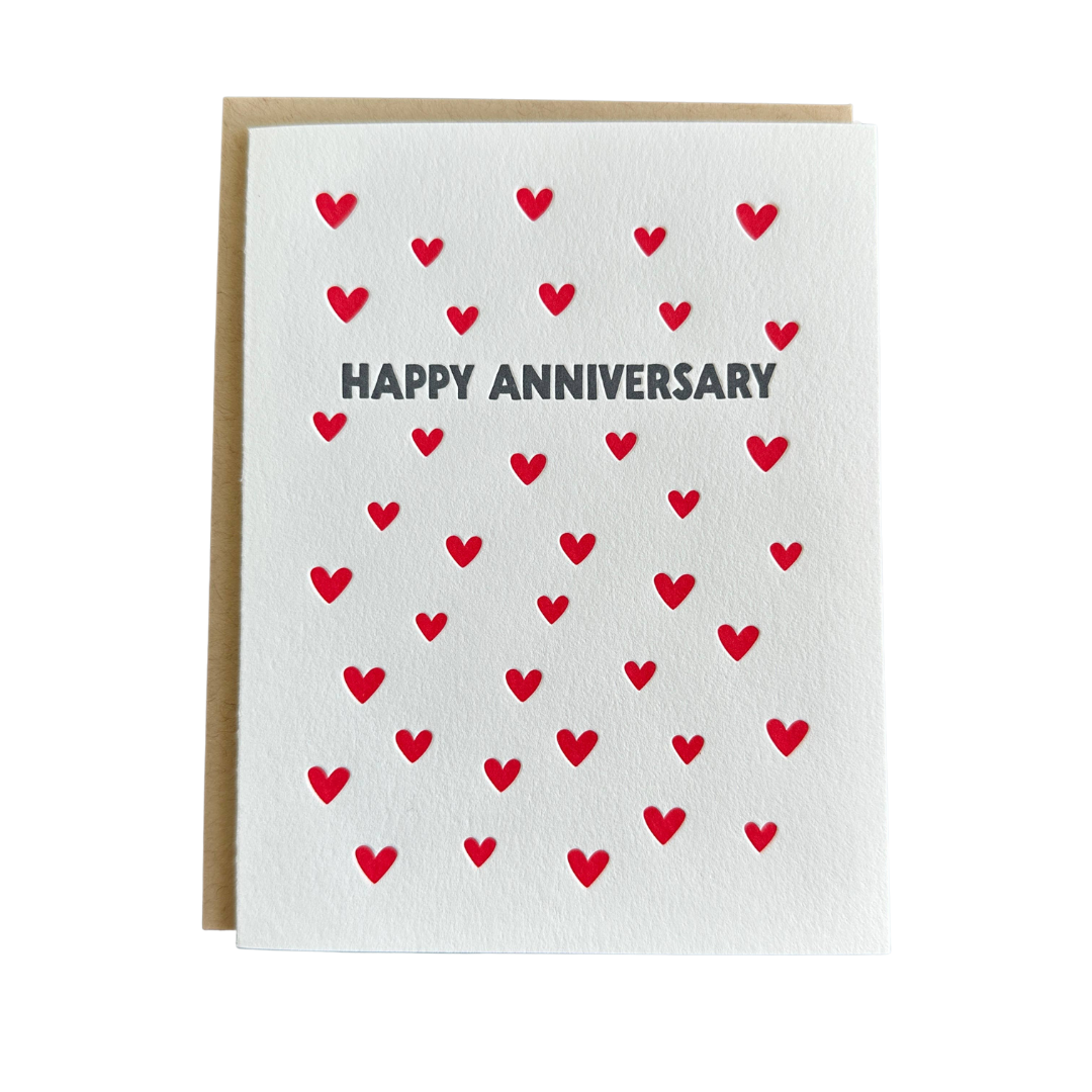 Greeting card with red hearts and 'Happy Anniversary' text on a white background