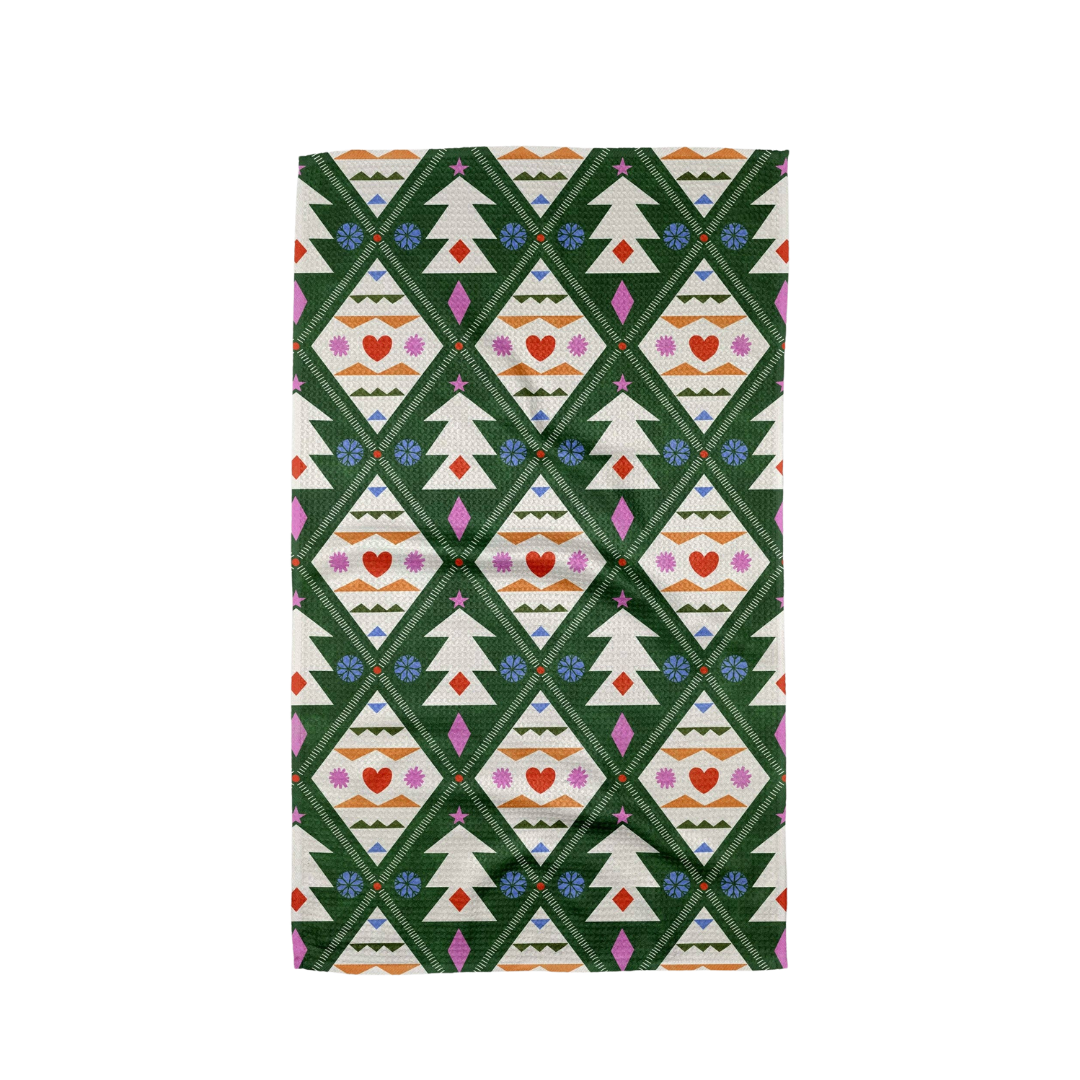 Patterned fabric with Christmas tree design on a green background