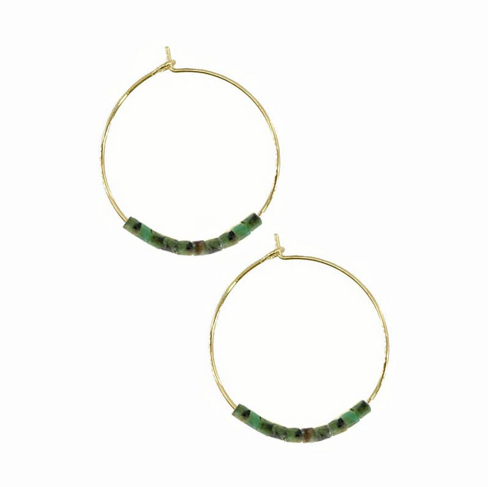 Gold hoop earrings with green beads on a white background