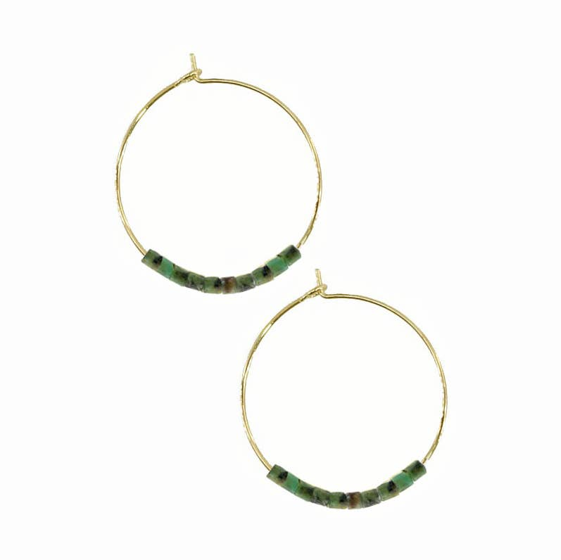 Gold hoop earrings with green beads on a white background