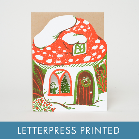 Letterpress printed card with a mushroom house design on a white background