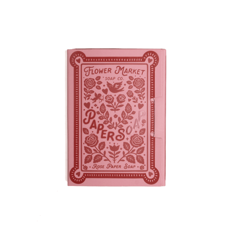 Pink soap packaging with floral design and text on a white background