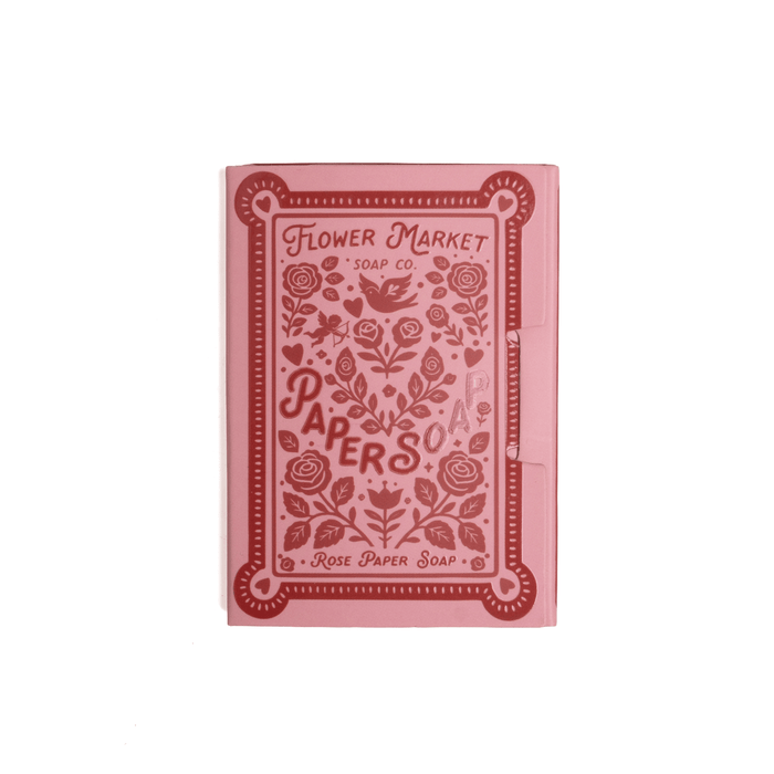 Pink soap packaging with floral design and text on a white background