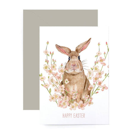 Easter card with a rabbit among flowers and 'Happy Easter' text on a white background.