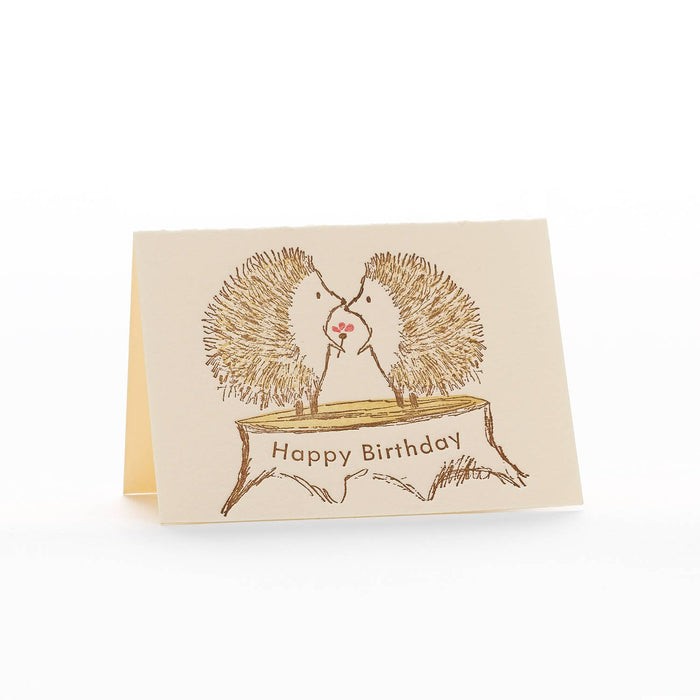 Birthday card with hedgehogs on a branch and 'Happy Birthday' text.