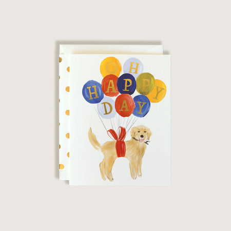 Greeting card with a dog holding balloons spelling 'Happy Day' on a white background