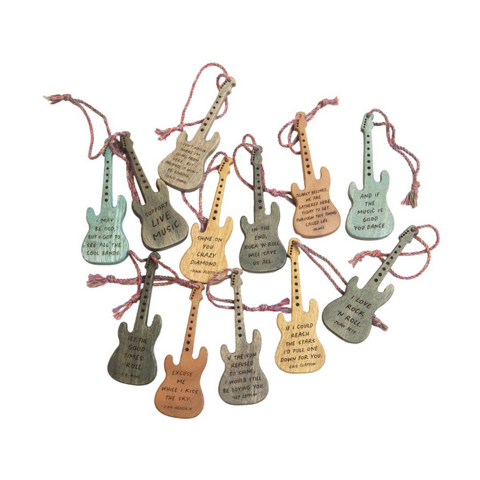 A set of guitar-shaped hanging ornaments in various muted colors, each with a pink string and engraved with motivational music-themed quotes on a plain white background.