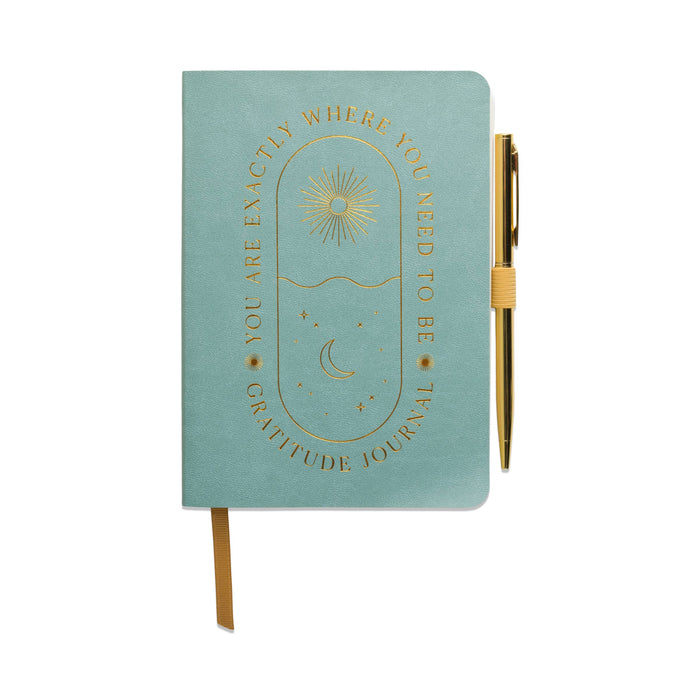 Teal gratitude journal with gold pen on a white background