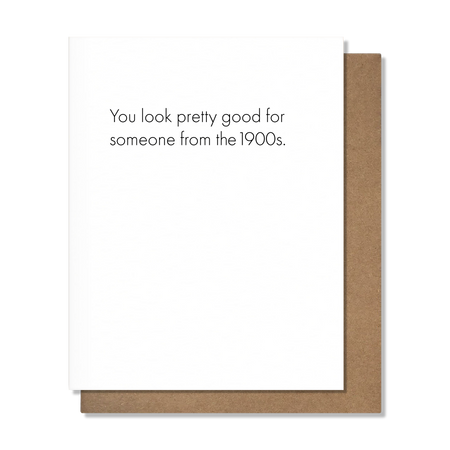 Card with text 'You look pretty good for someone from the 1900s.' on a white background with brown border.