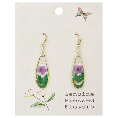 pair of gold earrings with purple pressed flowers, displayed on a white card