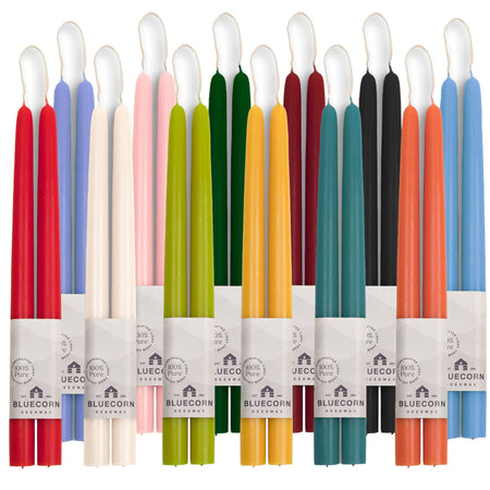 Set of colorful candles in various packaging with a visible brand name.