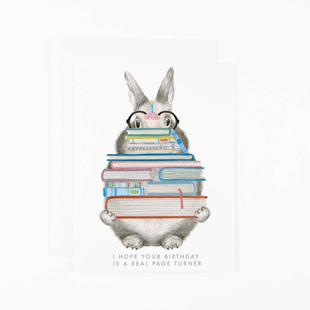 Illustration of a cartoon character with glasses reading books, with text 'I hope your birthday is a real page turner' on a white background.