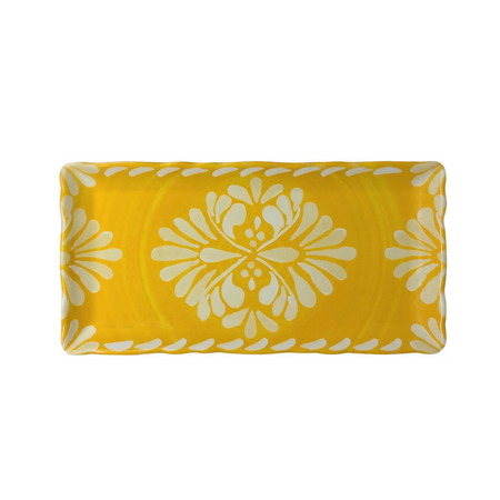 Yellow tray with white floral pattern on a white background