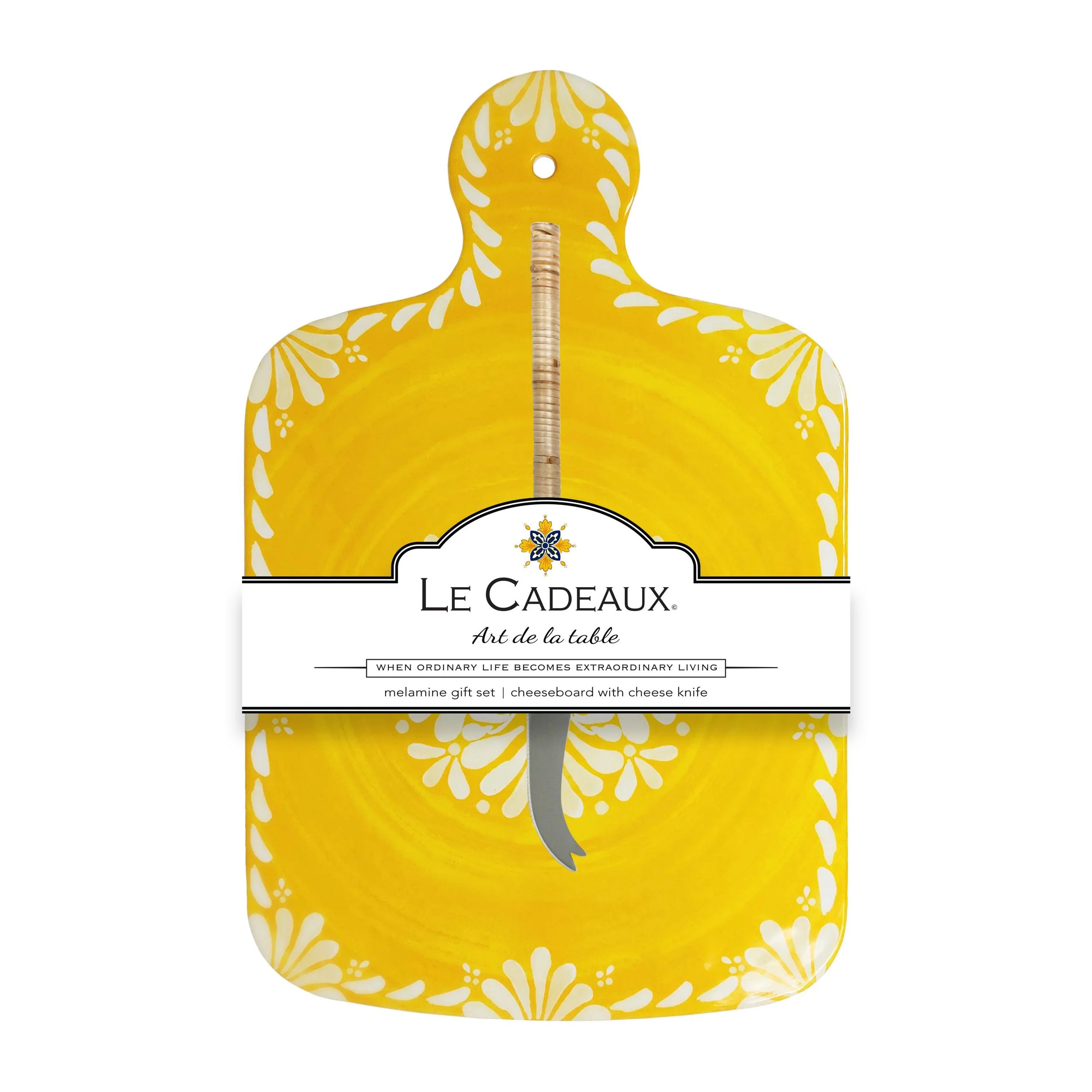 Yellow cutting board with floral patterns and Le Cadeaux branding on a white background
