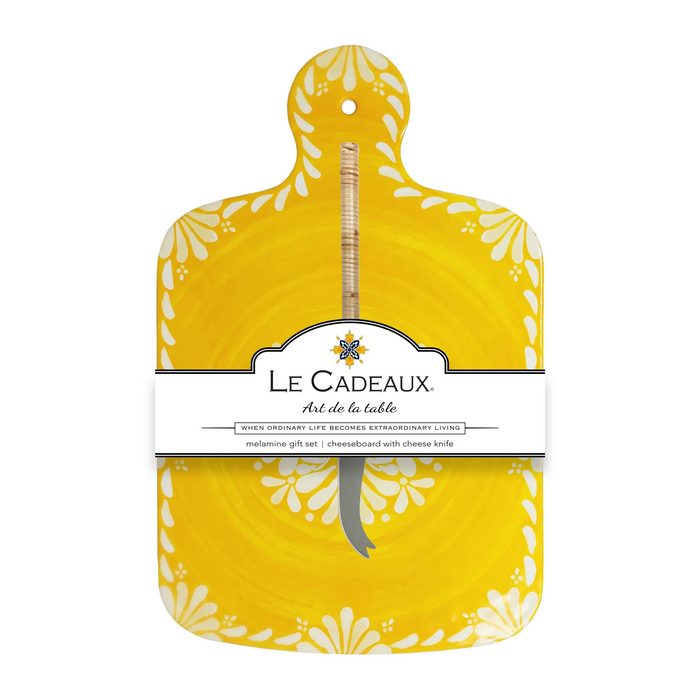 Yellow cutting board with floral patterns and Le Cadeaux branding on a white background