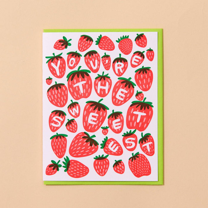Card with strawberry design and text on a beige background