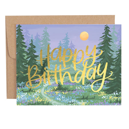 Greeting card with 'Happy Birthday' text in a forest setting, featuring trees and a moon.
