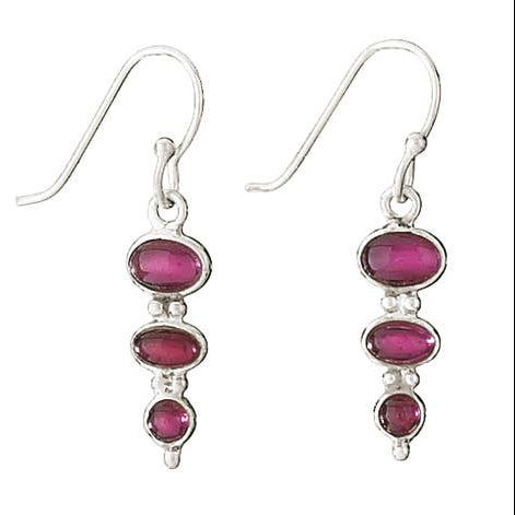 Silver earrings with garnet gemstones on a white background