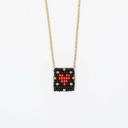 Necklace with a beaded heart pendant on a white background