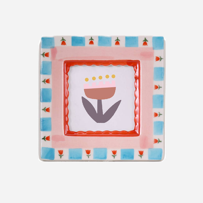 Decorative plate with floral design and colorful border on a white background