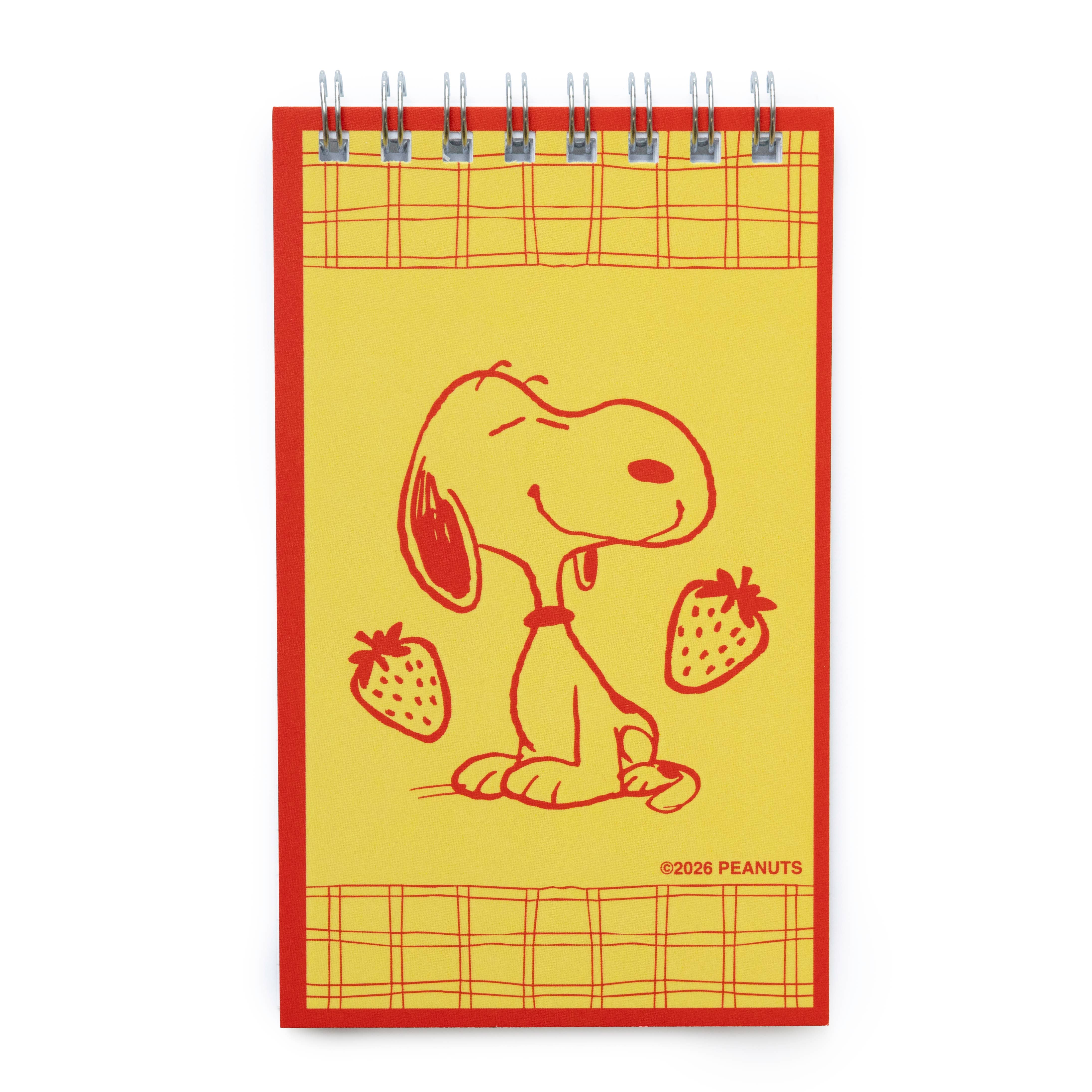 Notebook with a red border featuring snoopy and strawberries on a yellow background.