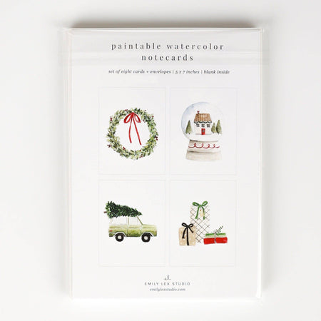 Packaging of paintable watercolor notecards with Christmas-themed illustrations on a white background.