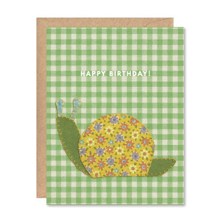 Birthday card with a floral snail design on a green checkered background