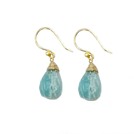 Gold earrings with teal teardrop-shaped stones on a white background