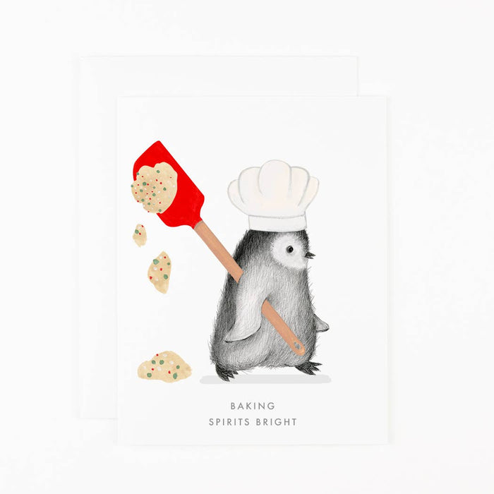 Illustrated card with a penguin in a chef's hat and a red spatula, title 'Baking Spirits Bright'.