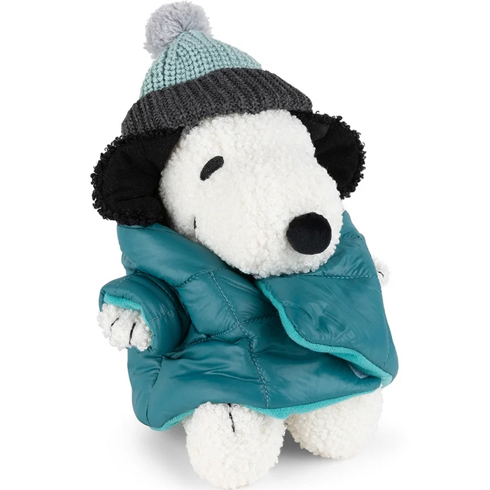 White Snoopy plush wearing a teal puffer jacket and a knit pom-pom hat with a dark gray brim