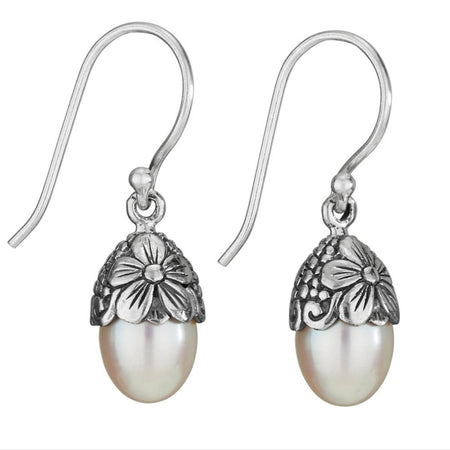 A pair of sterling silver dangle earrings with a floral pattern at the top and a pearl dangle at the bottom.