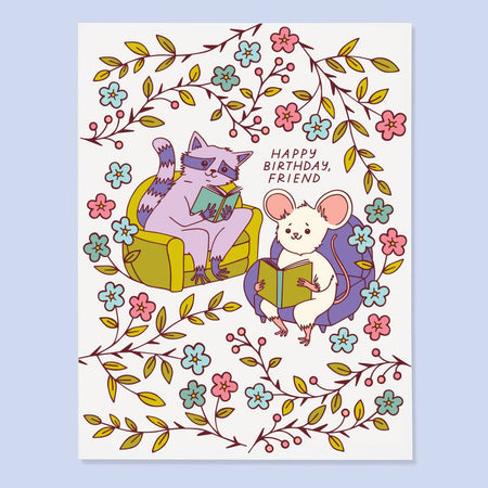 Illustration of a cat and mouse reading books with floral decorations on a birthday card.
