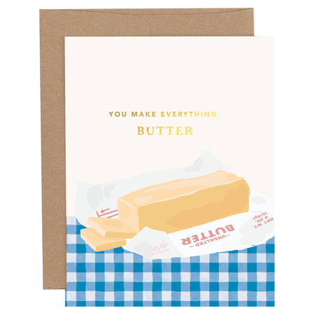 Greeting card with a stick of butter illustration and text 'You Make Everything Butter' on a blue checkered background.