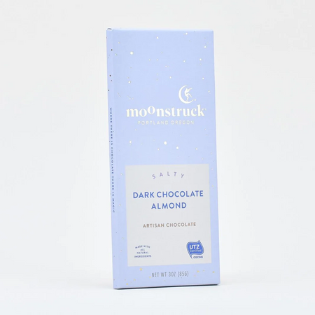 A single Moonstruck Dark Chocolate Almond bar in a light blue paperboard wrapper, photographed against a clean white background.