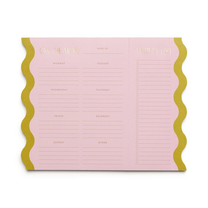Pink planner with gold accents on a white background