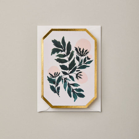 Greeting card with green leaf design and gold border on a beige background