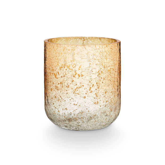Winter White candle in a rounded glass vessel with a mottled gold and silver-toned metallic finish.