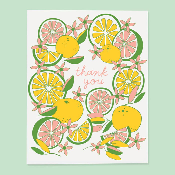 Card with citrus fruit design and 'thank you' text on a light green background