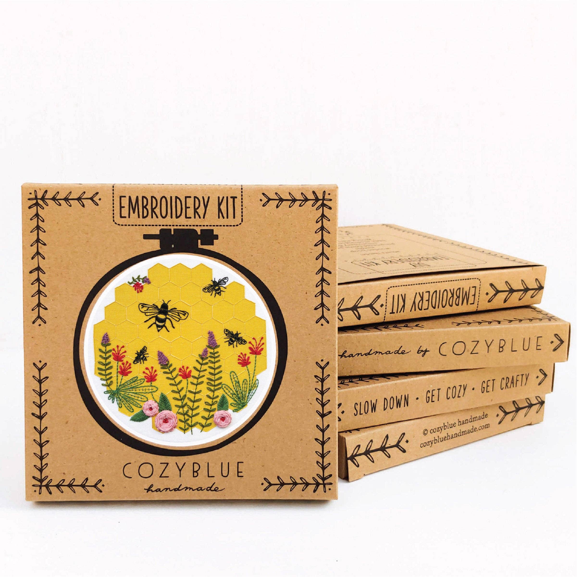 Embroidery kit packaging with floral design and 'CozyBlue' branding on a white background