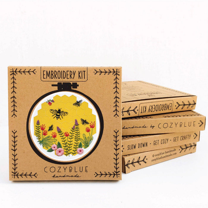 Embroidery kit packaging with floral design and 'CozyBlue' branding on a white background